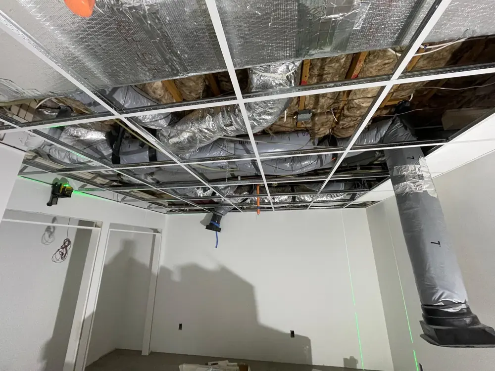 Drop ceiling grid going in under open ductwork