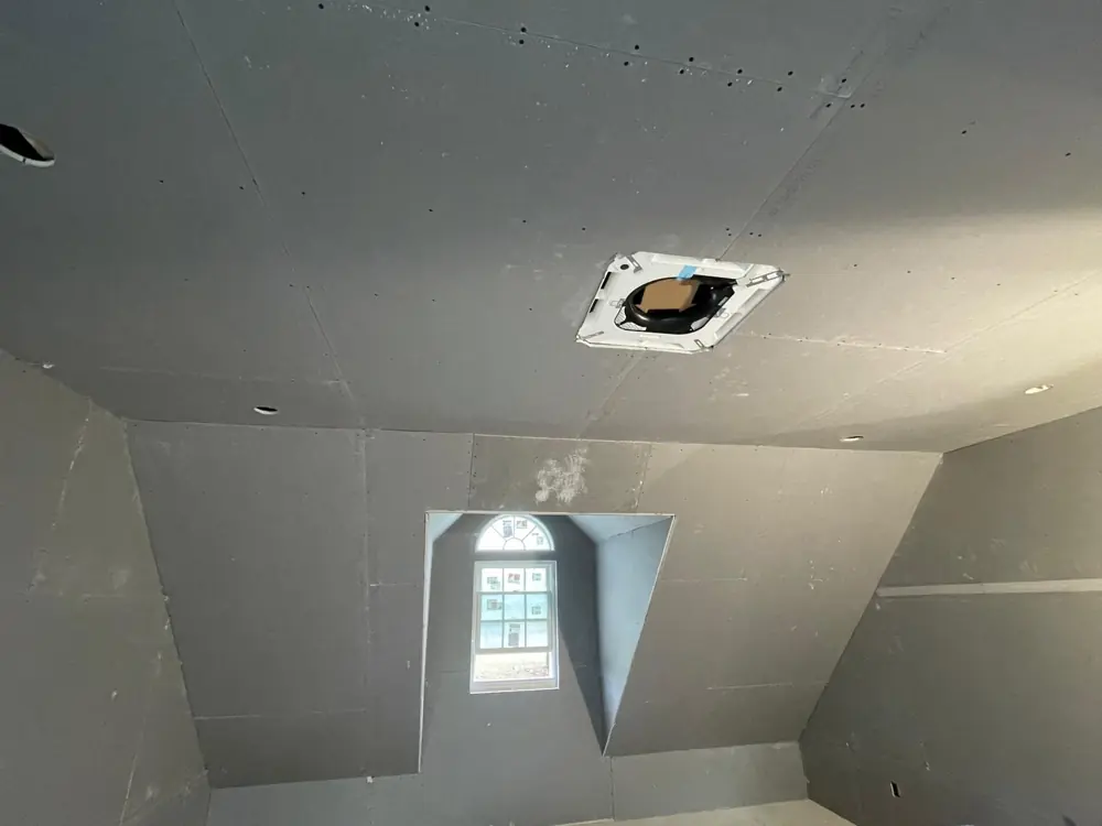 Sloped ceiling with dormer window, drywall hung
