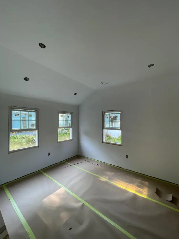 Bedroom with new drywall hung on walls and ceiling