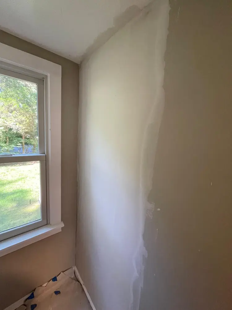 Wall skim coated smooth beside a window