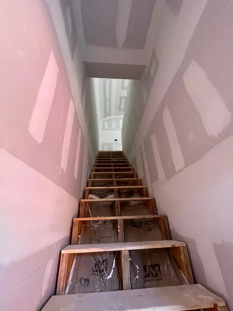 Stairwell with taped and coated drywall