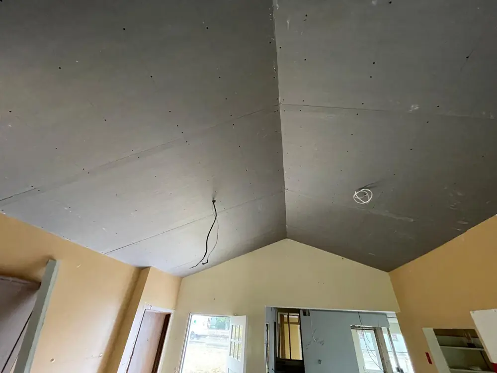 Vaulted ceiling hung with new drywall
